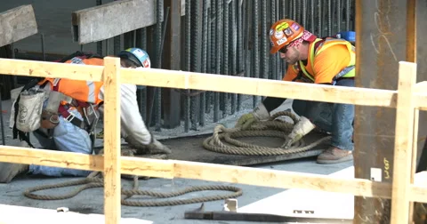 4k Construction workers wrapping rope Stock Footage 51058207