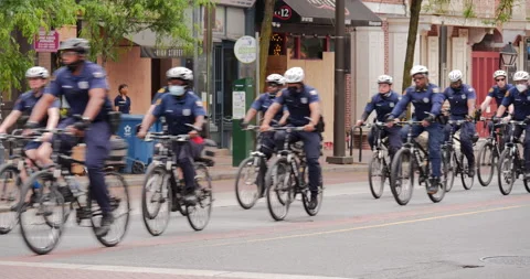 4K COPS ON BIKES RIDING PAST BOARDED UP BUSINESSES Video stock 132596946