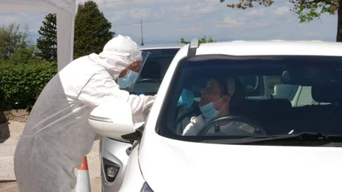4K: Coronavirus COVID-19 Drive through Testing station - Mouth Swab in the car. Stock Footage