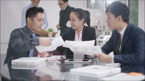 4K Corporate business group in a meeting with businessmen shaking hands in foreg Stock Footage