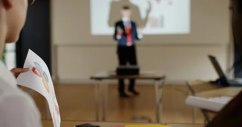 4K Corporate group looking at the figures &amp; listening to speaker in a seminar Stock Footage 101355525