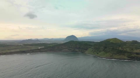 4K Counter-clockwise Aerial Long Shot of Songaksan (송악산) Mountain, Jeju Island Stock Footage 143864223