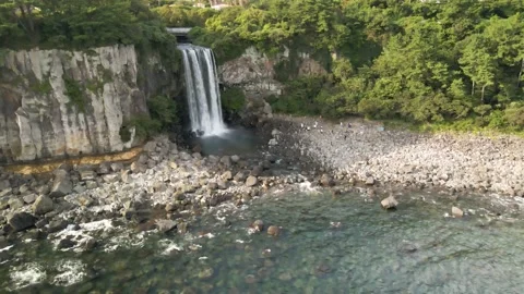 4K Counter-clockwise High Drone View of Jeongbang Waterfall (정방폭포), Jeju Island Stock Footage 143863441