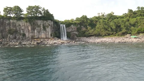4K Counter-clockwise Low Drone View of Jeongbang Waterfall (정방폭포), Jeju Island Stock Footage 143863418