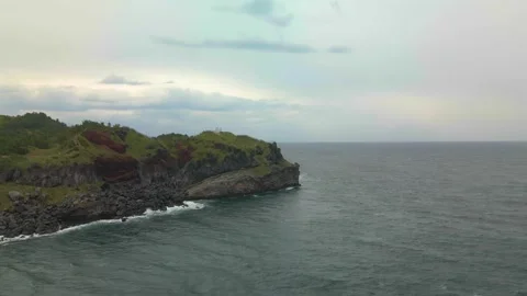 4K Counter-clockwise Wider Aerial View of Songaksan (송악산) Mountain, Jeju Island Stock Footage 143864295