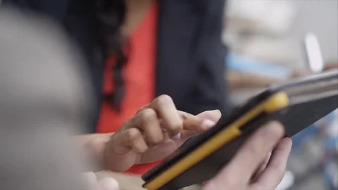 4K Couple Chatting &amp; Looking At Computer Tablet At Outdoor Cafe Table In City Stock Footage 75675743