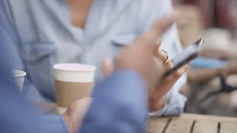 4K Couple Chatting &amp; Looking At Computer Tablet At Outdoor Cafe Table In City Stock Footage 75712310