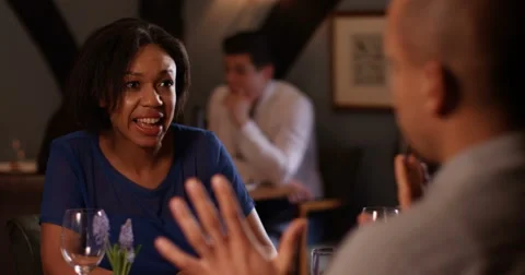 4K Couple having an argument in restaurant with focus on woman Stock Footage 62905996