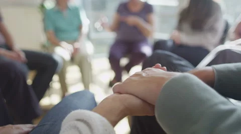 4K Couple holding hands for support during group therapy session. Focus on hands Stock Footage 44638001