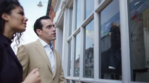 4K Couple looking in window of a man's clothing store.  Stock Footage 68341066