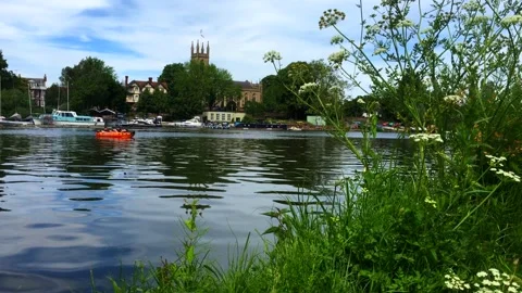 4k, Couple pass by in small inflatable boat on river Thames at Hampton Court Stock Footage 132200730