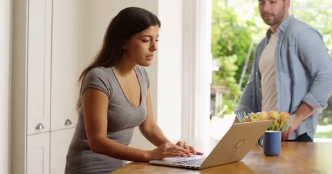 4K Couple spending time together at home, looking at laptop computer 動画素材 80099484