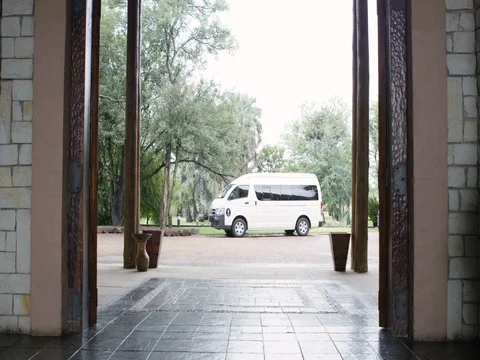 4K Couple on vacation arriving at hotel & checking in at reception Stock Footage