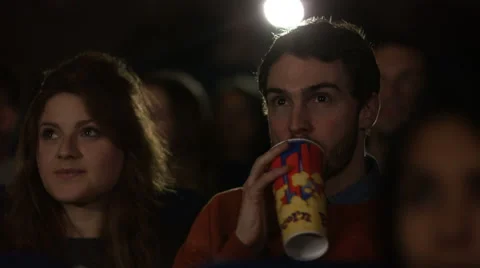 4K Couple watching film in busy movie theatre Stock Footage 59673938
