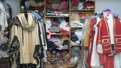 4K couple of young men checking clothes rack in vintage shop Stock Footage 90800835