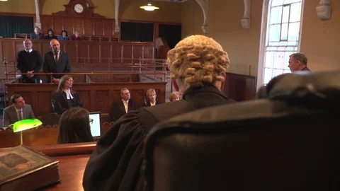 4K: Court / Courtroom trial. Witness questioned. Behind the Judge. Wig. Stock Footage