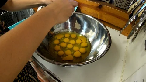 4k Cracking eggs open into large mixing bowl Stock Footage 97462006