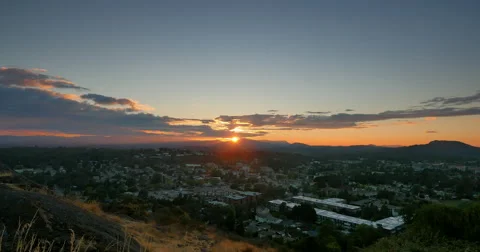 4K Crane Elevate Shot of Setting Sun on Distant Hills, Blue and Orange Sky Stock Footage 47127101