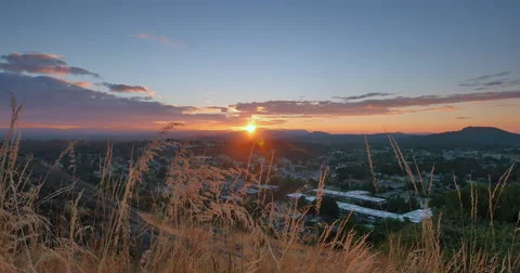 4K Crane Pan of Distant Hills, Tall Summer Grass and Sunset in Distance Stock Footage 47123478