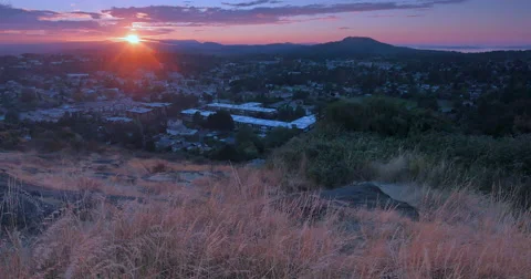 4K Crane Shot through Tall Grass Overlooking Distant Hills and Purple Sky Sunset Stock Footage 47127694