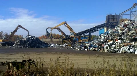 4K Cranes at the Scrap Yard Junk Yard Moving Piles Of Metal Video stock 68849740