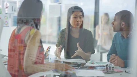 4K Creative business team looking at photos &amp; printed graphs in a meeting Stock Footage 76032917