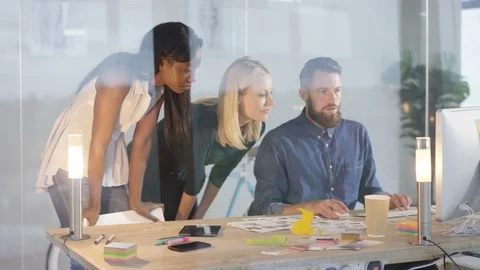 4K Creative design team brainstorming for ideas in front of computer Stock Footage 69759112