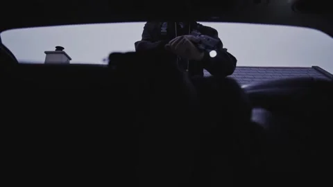 4k Crime Shot of Detective looking at Victim in the Car Boot Stock Footage 321865624