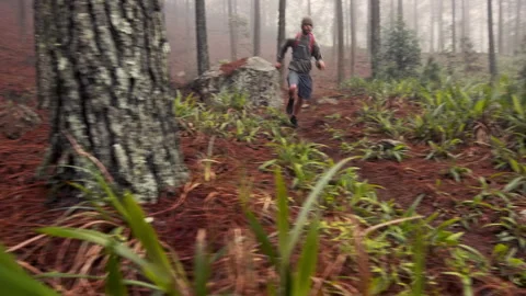 4k Cross country runner man,putting in headphones, running and exercising on a m Stock Footage 199621164