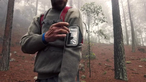 4k Cross country runner man,selecting music or app, putting in headphones, runni Stock Footage 199621175