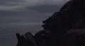 4k dark atmospheric shot of rocky cliffs over the sea, clouds move across sky 4k or 4k+ Resolution