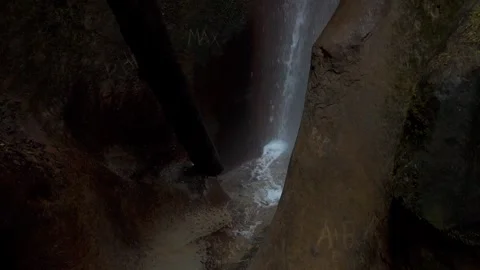 4K Dark Cave Waterfall Pan Down - Sombrio Beach Vancouver Island, BC Stock Footage 321147761