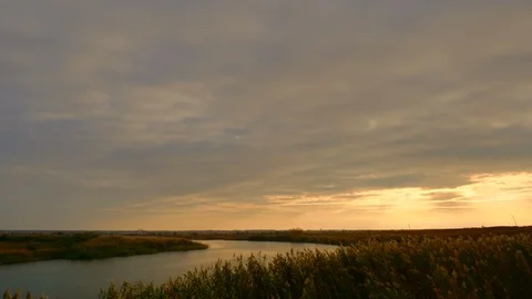 4K Dark clouds over the bend of the river at sunset. Windy autumn sky. Stock Footage 97161870