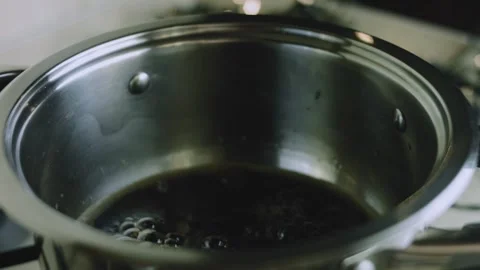 4K Dark Cola Syrup Simmering Gently on the Stovetop Video stock 342112930