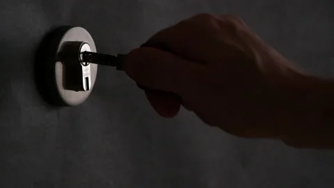 4K - In the dark, a hand inserts the key into the lock Stock Footage 163226535