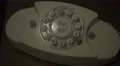 4K Dark yellowish footage of a hand dialing on an old fashioned vintage phone 4k or 4k+ Resolution