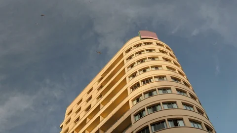 4k day low angle detail static shot of the top of a high rise art deco style Stock Footage 124576819