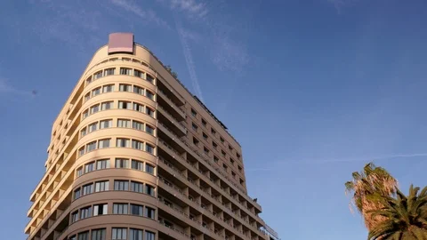 4k day wide low angle static shot of the top of a highrise art deco style Stock Footage 124551597