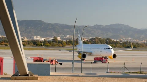 4k daylight static shot of a parked big white passenger airplane on an airstrip Stock Footage 123773841