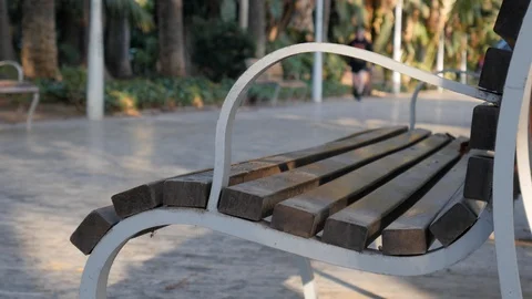 4k daylight static shot selective focus of a young man in walking in a park Stock Footage 123429688