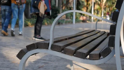 4k daylight static shot selective focus of an small group people in a park alley Stock Footage 123429737