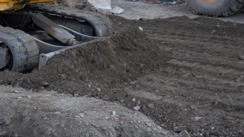 4k daylight tight shot of a small bulldozer moving soil on a construction site Video stock 122645130