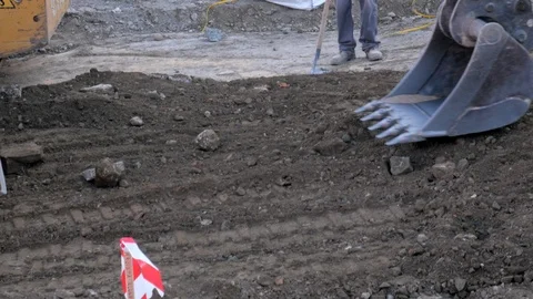 4k daylight tracking shot of the bucket of an excavator flattening terrain. Stock Footage 122990979
