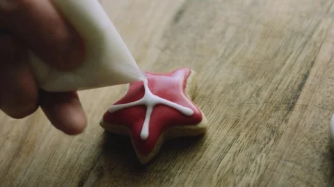4K Decorative White Pattern Drawn Across a Red Star Cookie Stock Footage 342113680