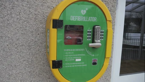 4K: A Defibrillator AED hanging outside a building on the wall for First Aid Video stock 325795127