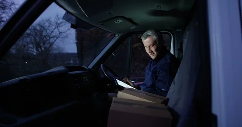 4K Delivery driver with negative attitude sitting in van checking parcels Stock Footage 85542672