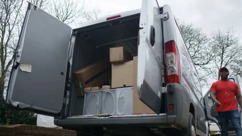 4K Delivery driver unloading boxes from the back of van Stock Footage 69110053