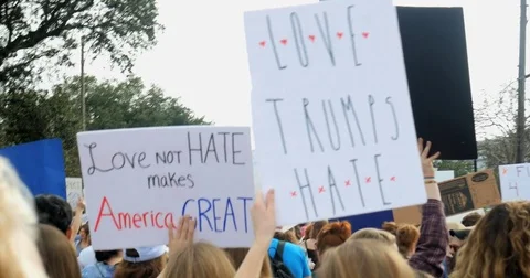 4K Demonstrators hands arms marching and carrying signs Love makes America Great Stock Footage 73777984
