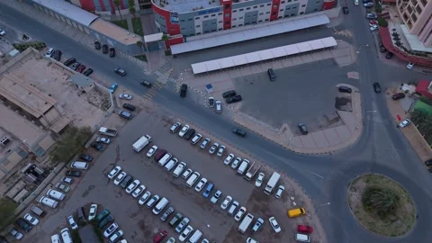 4K Descending Drone View Over Urban Parking Lot and City Intersection Stock-Footage 311034754