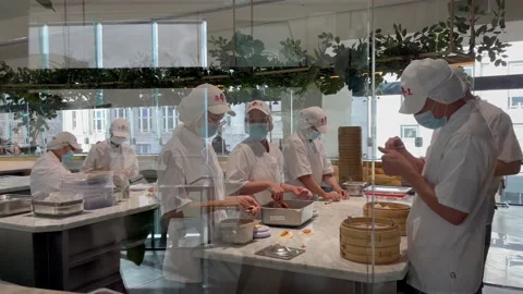 4K Dim sum chefs at Centre point's Din Tai Fung restaurant top floor Stock Footage 219940558